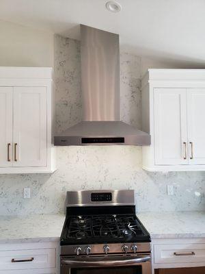 Wall hood with CUSTOM stainless steel stack cover engineered and installed by PDQ to work with cathedral ceiling