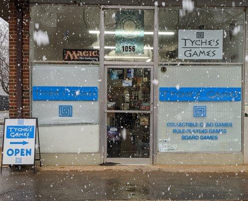 Storefront during snowfall.