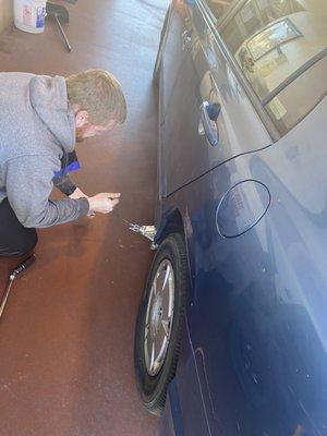 Jonathan changing a tire after hours