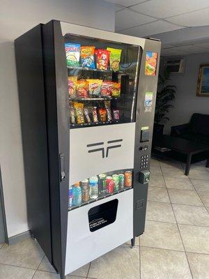 Waiting area that has vending machine to make sure customers aren't hungry and thirsty!