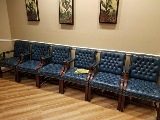 Simple but comfortable waiting room with plenty of reading material.