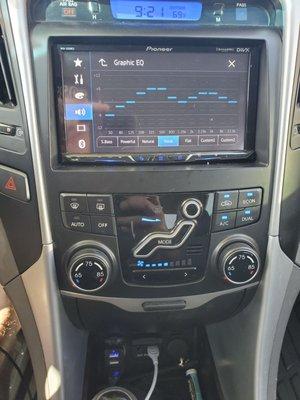 Custom EQ + Android/Apple car play custom port at the bottom middle (white cable plug in)