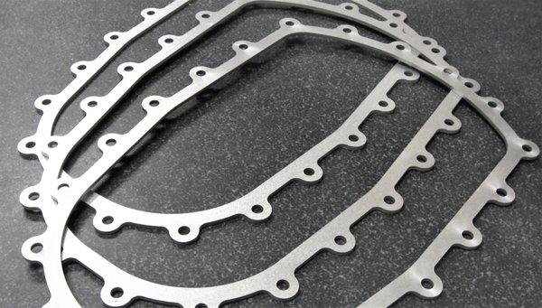 Abrasive waterjet cut stainless steel brackets with mounting holes. This gaskets are strong and uniform.