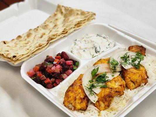 Chicken tender with rice and sides of vinaigrette salad and yogurt mixed with spinach