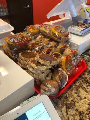 Desserts at the register to tempt you . They look yummy .