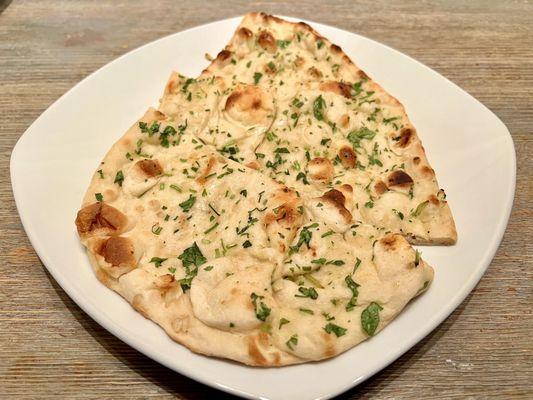 Garlic Naan. Soft, thin naan bread with garlic flavors. Perfect for dipping into the Saag Paneer.