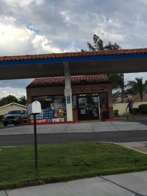 The mini mart stands between the gas pump aisles.