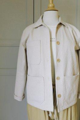 Classic chore jacket sample on a mannequin that students used as a example to make their own at the sewing workshop.