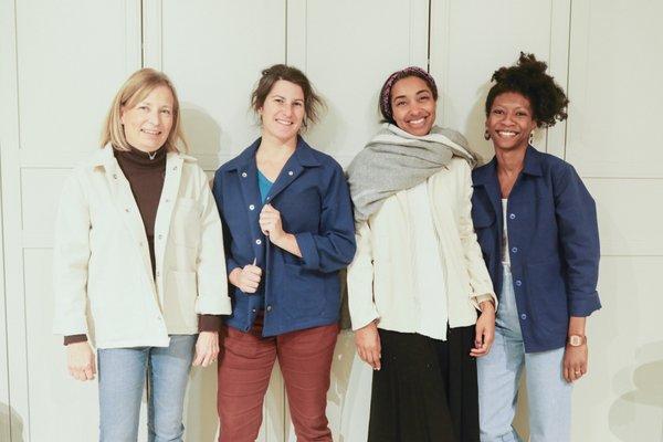 Students posing with their final garments. They made their own jacket in a day at a sewing workshop.