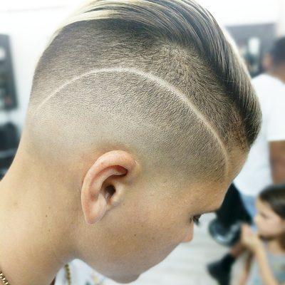 Low skin fade with a hard part