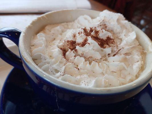 Café Latte with whip and cinnamon.