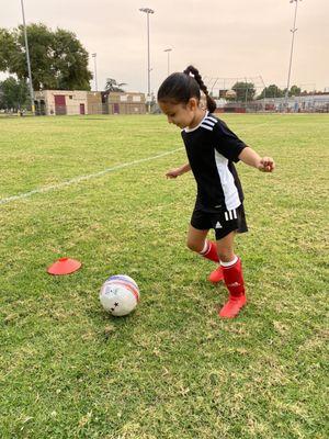 My little one wearing all her awesome gear! My favorite item is the laceless cleats.