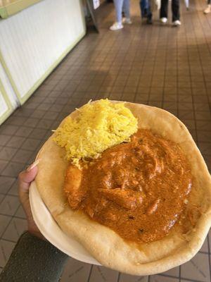 Butter chicken with rice on naan bread