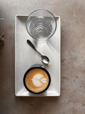 Cortado with a side of bubbly water