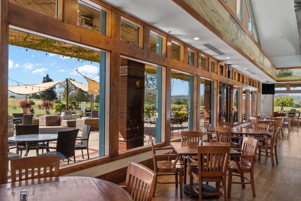 Interior shot of 12 Mile Station. Lots of windows showcasing views of the Tournament Course and our Outdoor Dining area at our Rose Garden.