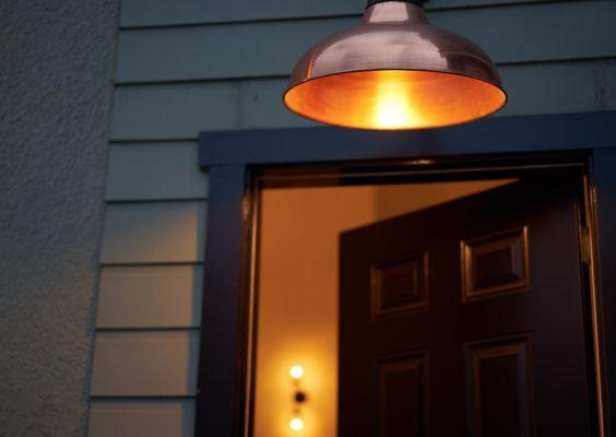 Entrance on side of building. Nevada St. side. Solid black door with copper lamp above it.