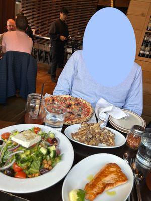 Mediterranean Salad, salmon, crispy cauliflower, and pizza.