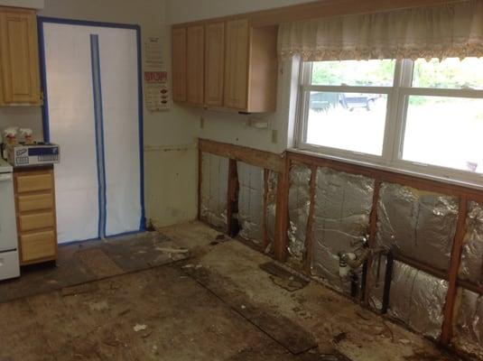 Kitchen with rotted ply wood floor due to flood.