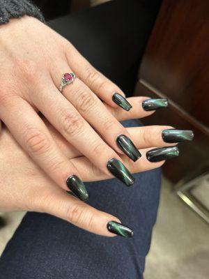 Coffin shaped acrylic nails with green cat eye nail polish