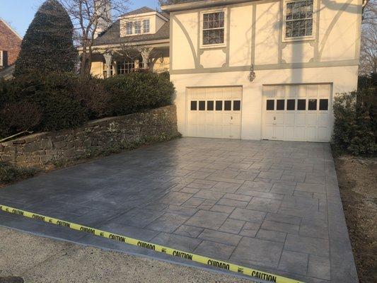 Colored concrete stamped in a flagstone pattern.