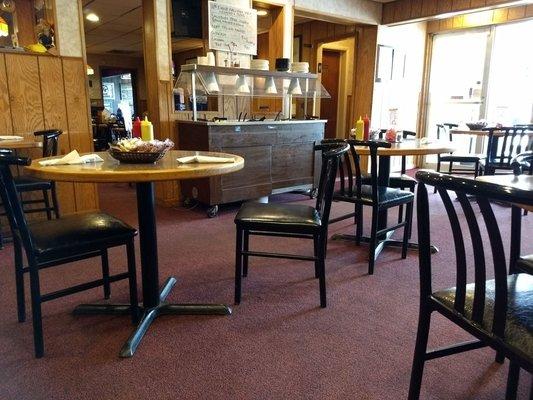 Dining room with small salad bar in the background.