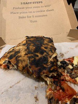 Burnt pizza.  Seriously can't believe they delivered this.  Wow.