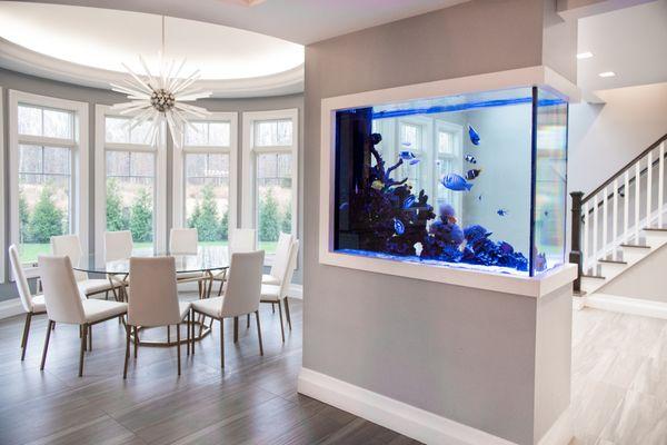 Aqua Creations designed, installed, and maintains this custom built-in fish tank in a Lakewood, NJ home, showcasing our teams dedication.