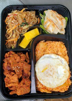 Spicy Pork Lunch Box (Bento Box). Delicious spicy pork, kimchi fried rice, vegetable Japche noodles, and pork & vegetable mandoo dumplings.