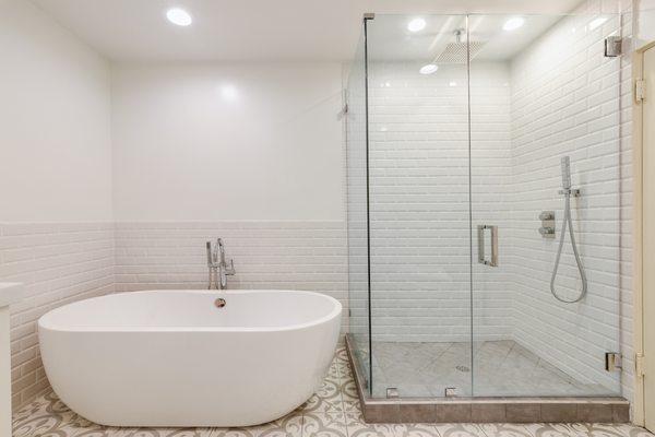 Modernize up your bathroom space with recessed lighting, frameless glass shower doors and a free standing tub with the best remodeling team.