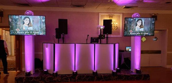 DJ set up with uplighting and TVs