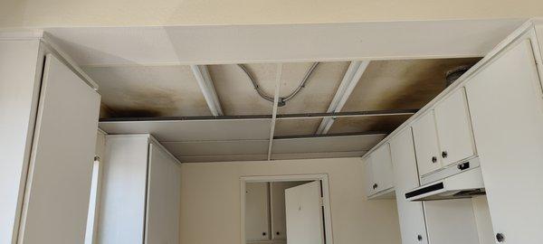 Drop down ceiling removal and recessed light installation.