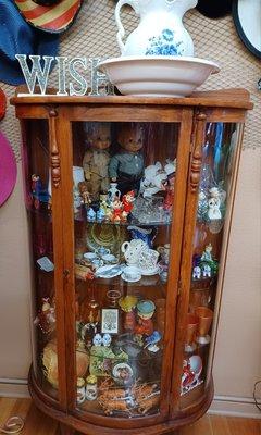 Curio full of collectibles including kewpie dolls, carnival glass & more