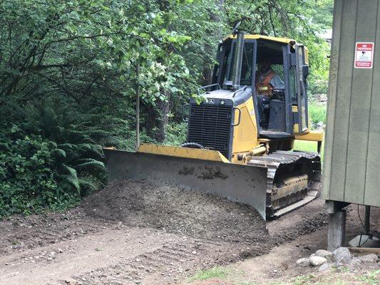 Smoothing out a customers driveway to make the potholes disappear