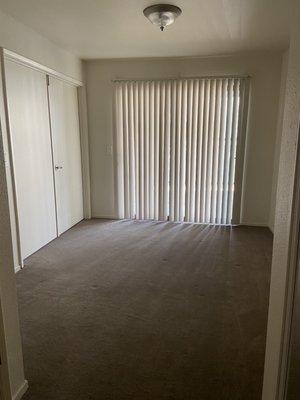 Bedroom with sliding door to patio(technically this is a studio apartment, but they have doors separating the bedroom and living room)