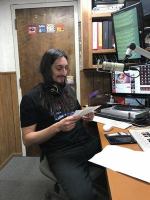 Local artist Anthony Bianconi aka DJ Spaceman reading public announcements during his New Retro Wave show Clocks & DeLoreans.