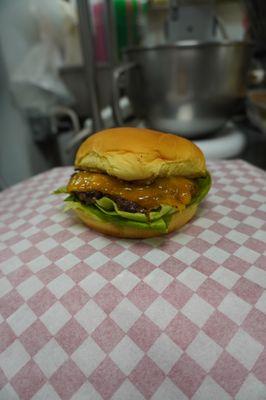 Single Cheese Burger with lettuce and tomatoes.