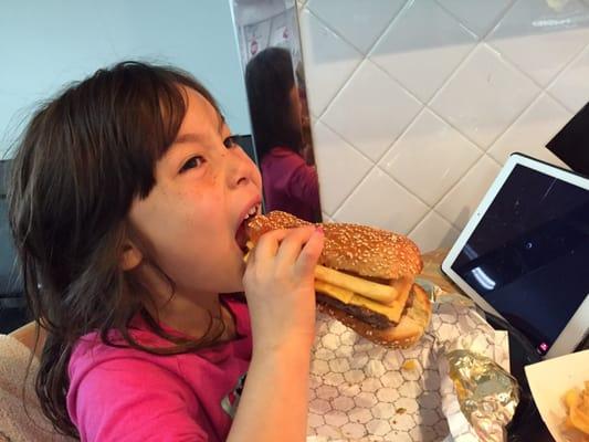 My daughter enjoying her cheeseburger