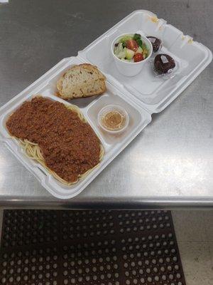 Spaghetti w/meat sauce, salad, italian dressing, garlic bread, and a brownie