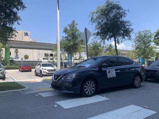 Roy's Delivery parked in front of the cross walk preventing individuals with wheelchairs, walkers and strollers to access the hospital.