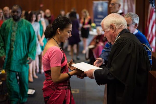 The IIHA's University Professor and Director, Kevin Cahill, M.D., presents a student with her diploma at graduation.