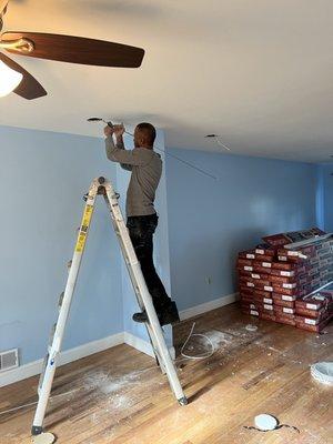 Installing recessed lights.