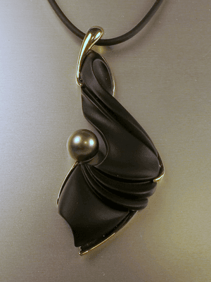 Hand carved onyx with pearl and 14 k gold.