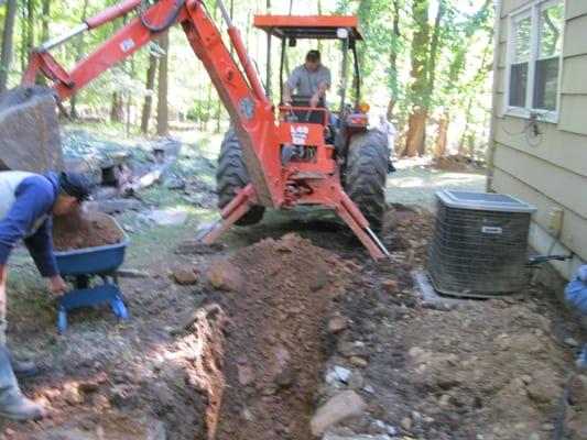 Excavating for property drainage system