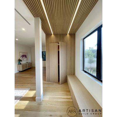 Hand selected rift cut white oak screens with built in cabinetry & hidden closet door panels.