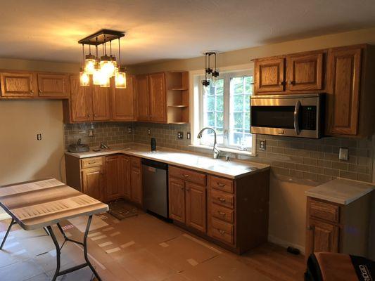 A before photo of the kitchen cabinets.