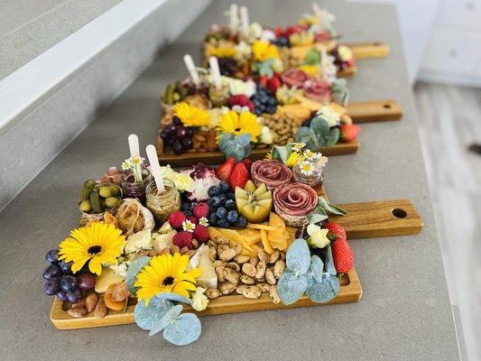 Paddle boards are a nice way to showcase charcuterie, and to be placed in the center of each table for grazing while pairing with wine.