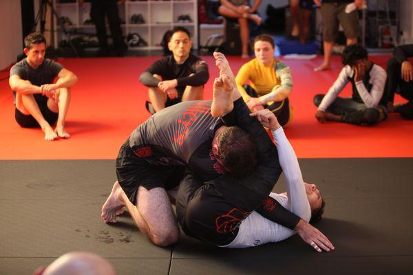 Head Coach Chad Vazquez demonstrating a BJJ technique.