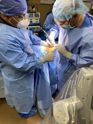 Dr. Hossain and Dr. Mitchell in surgery