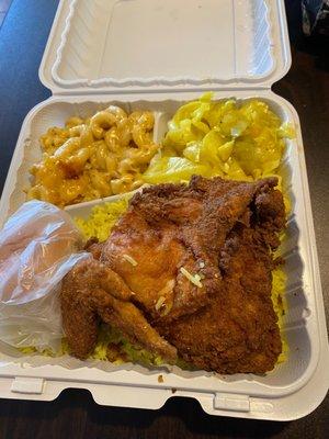 Fried chicken dinner with rice, cabbage, macaroni & cheese and a roll.