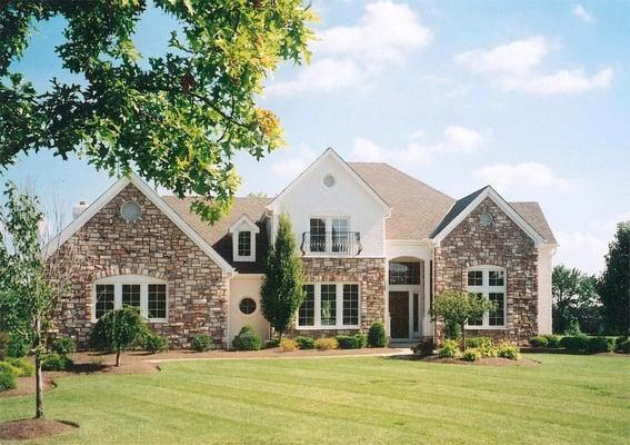 We blended adding cultured stone with painting the brick.  A dormer, Juliet balcony rail and columns and arch at porch brough...